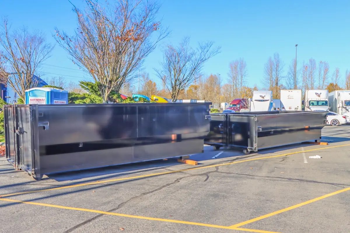 Professional dumpster rental service with roll-off container on residential driveway in San Francisco